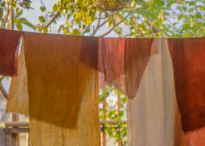 Hand dyed fabrics drying on a line