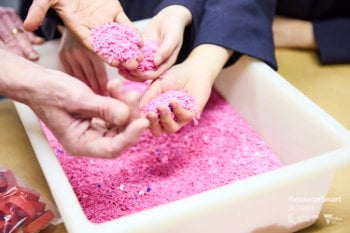 Students run their hands through recycled plastic as part of the RSS program