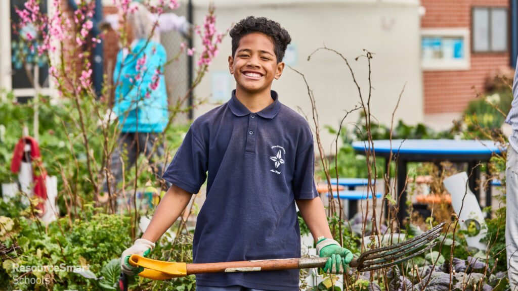 A boy turns compost as part of the ResourceSmart School program facilitated by CERES